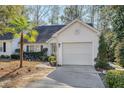 White house with palm tree and garage at 9117 Woodcreek Ct, North Charleston, SC 29406