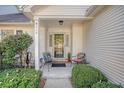 Front entrance with two chairs and shrubs at 9117 Woodcreek Ct, North Charleston, SC 29406
