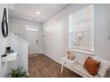 Bright entryway with wood floors, bench, and coat rack at 9702 Roseberry St, Ladson, SC 29456
