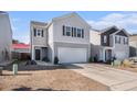 Two-story house with gray siding, white garage door, and landscaping at 9702 Roseberry St, Ladson, SC 29456
