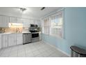 White cabinets, stainless steel appliances, and light blue walls at 1101 Reserve Way, Summerville, SC 29485