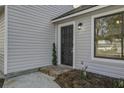 Dark-stained front door with a brick walkway at 117 Hummingbird Ave, Ladson, SC 29456