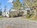 View of the home's long side, showing its size and gravel driveway at 138 Green Pond Hwy, Walterboro, SC 29488
