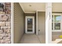 Front entrance with a white door and stone accents at 187 Weeping Cypress Dr, Moncks Corner, SC 29461
