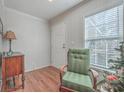 Bright entryway with wood floors, green chair, and antique side table at 208 Catfish Landing Cir, Bonneau, SC 29431