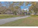 Exterior view of a single-story home with a spacious yard and boat storage at 208 Catfish Landing Cir, Bonneau, SC 29431