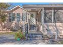 House front entry with steps leading to a screened porch at 208 Catfish Landing Cir, Bonneau, SC 29431