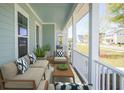 Relaxing front porch with outdoor seating and neighborhood views at 2841 Auldreeke Rd, Johns Island, SC 29455