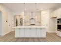 Modern kitchen featuring a large island, white cabinets, and gold accents at 2841 Auldreeke Rd, Johns Island, SC 29455