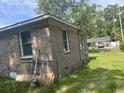 Brick home corner showing small windows and grassy yard at 310 Adeline Dr, Goose Creek, SC 29445