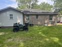 Backyard view with ATV parked next to a house with mixed siding at 310 Adeline Dr, Goose Creek, SC 29445