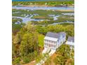 Waterfront property surrounded by lush greenery and other homes at 3578 Clambank Dr, Mount Pleasant, SC 29466