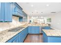 Blue kitchen cabinets, granite countertops, and stainless steel appliances at 4240 William E Murray Blvd, Charleston, SC 29414