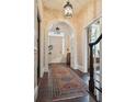 Elegant entryway with arched doorways, hardwood floors, and a patterned rug at 43 Hasell St, Charleston, SC 29401