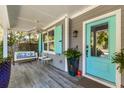 Front porch features a white swing, ceiling fan, and blue front door at 469 Fort Johnson Rd, Charleston, SC 29412