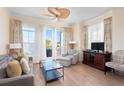 Spacious living area featuring a ceiling fan, comfortable furniture, and hardwood floors at 5804 Palmetto Dr # A-201/203, Isle of Palms, SC 29451