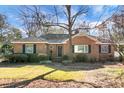 Brick home with black front door and mature trees at 917 S Main St, Summerville, SC 29483