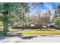 Front view of charming brick home with mature trees at 917 S Main St, Summerville, SC 29483