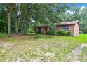 Brick ranch house nestled among large trees at 1088 Quiet Rd, Mount Pleasant, SC 29464