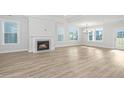 Spacious living room with hardwood floors, fireplace, and large windows at 115 Crosscut Ln, Summerville, SC 29486