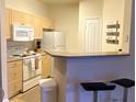 Well-equipped kitchen with white appliances and ample cabinetry at 1300 Park West Blvd # 110, Mount Pleasant, SC 29466