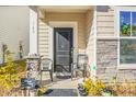 Front porch with two black chairs and stone accents at 149 Cypress Preserve Blvd, Moncks Corner, SC 29461