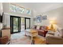 Spacious living room featuring a large window and sliding doors to a balcony at 149 High Hammock Villas, Seabrook Island, SC 29455