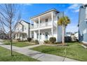 Two-story white house with palm trees and a manicured lawn at 212 Magnolia Garden Dr, Summerville, SC 29483