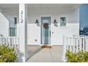 Front door entry with light blue door and white columns at 212 Magnolia Garden Dr, Summerville, SC 29483