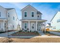 Two-story house with light blue siding, front porch, and driveway at 225 Witherspoon St, Summerville, SC 29486