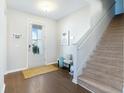 Bright entryway with hardwood floors, staircase, and bench at 2700 Sunrose Ln, Johns Island, SC 29455