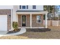 Front entrance with brick columns, a black door and a small walkway at 2700 Sunrose Ln, Johns Island, SC 29455