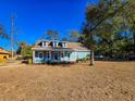 Blue house with a front porch, side yard, and a spacious lawn at 273 Plantation Ln, Walterboro, SC 29488