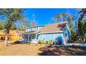 Light blue house with a front porch, side yard, and new construction behind it at 273 Plantation Ln, Walterboro, SC 29488