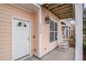 Front entrance with white door, rocking chairs, and covered porch at 2978 Sugarberry Ln, Johns Island, SC 29455