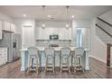 Bright kitchen featuring white cabinets, island with seating, and stainless steel appliances at 3012 Emma Ln, Mount Pleasant, SC 29466