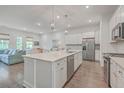Open concept kitchen boasts white cabinets, large island, and stainless steel appliances at 3012 Emma Ln, Mount Pleasant, SC 29466