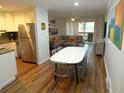 Open concept living and dining area with hardwood floors and modern furnishings at 345 Sea Cloud Cir # 345, Edisto Island, SC 29438