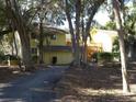 Back exterior of yellow building with driveway and landscaping at 345 Sea Cloud Cir # 345, Edisto Island, SC 29438