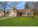 Tan house with a white garage door and landscaping at 359 Parish Parc Dr, Summerville, SC 29485