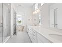 Elegant bathroom with dual vanities, a large shower, and bright lighting at 427 Evening Glow Ln, Summerville, SC 29486