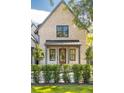 Tan brick home with a front porch and manicured hedges at 507 Mccants Dr, Mount Pleasant, SC 29464