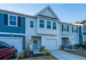 Two-story townhome with gray and white siding, two-car garage, and landscaping at 553 Trotters Ln, Moncks Corner, SC 29461