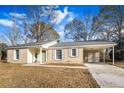 Newly renovated brick ranch home with carport and mature trees at 7640 Hillview Ln, North Charleston, SC 29420