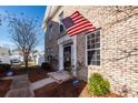 Brick front entrance with American flag, and security system at 826 Rue Dr, Charleston, SC 29414