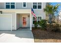 Red front door with porch and American flag at 9761 Transplanter Cir, Ladson, SC 29456