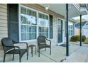 Two wicker chairs and small table on front porch at 124 Pointer Dr, Goose Creek, SC 29445