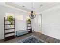 Elegant dining room featuring hardwood floors, wainscoting, and a lovely chandelier at 1493 Nautical Chart Dr, Charleston, SC 29414