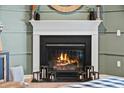 Cozy corner fireplace with a white mantel and warm fire at 2122 Leopold St, Johns Island, SC 29455