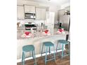 Kitchen island with granite countertop and teal stools at 343 Lake Ridge Blvd, Summerville, SC 29483